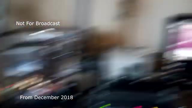 The 16mm still from the 'December 2018 transfer talk' shows a blurred and slightly chaotic view of a workspace, likely during the transfer process of a Chase and Sandborn commercial from film to video. The scene includes various equipment, suggesting a busy editing or post-production environment. Text overlays indicate that the content is 'Not For Broadcast' and timestamped as from December 2018. You mention that audio sync issues were present, which has since been addressed, explaining why this footage may not have been shared earlier.