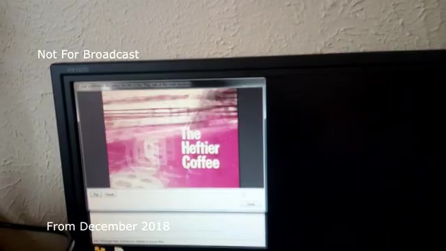 The still features a screen displaying a transfer of a TV commercial titled 'The Heftier Coffee.' The image indicates a digital version of the original 16mm film. On the top left, the text 'Not For Broadcast' suggests that this is a private or archival clip rather than a publicly shareable piece. The date, 'From December 2018,' adds context, indicating it was recorded during a transfer process, likely involving technical adjustments to address audio sync issues. Overall, it captures a moment in the transition from film to video format.