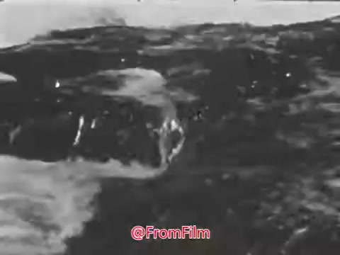 The still from the 'US Navy Recruiting PSA - 1960's' depicts a dynamic scene of waves crashing against the shore, emphasizing the power and presence of the sea. The accompanying voice-over reflects a poetic tone, suggesting a timeless connection between the ocean and the human experience. The imagery combined with the narration likely aims to evoke feelings of adventure and enlistment into a life at sea.