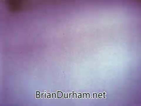 The still from the 1968 Red Rose Tea commercial showcases a close-up view with a soft, diffused background, likely featuring a vintage aesthetic typical of that era's advertisements. The scene may involve elements related to tea preparation or enjoyment, embodying a warm, inviting atmosphere. The film likely aimed to highlight the qualities of Red Rose Tea, appealing to viewers' senses and promoting a comfortable, cozy experience.