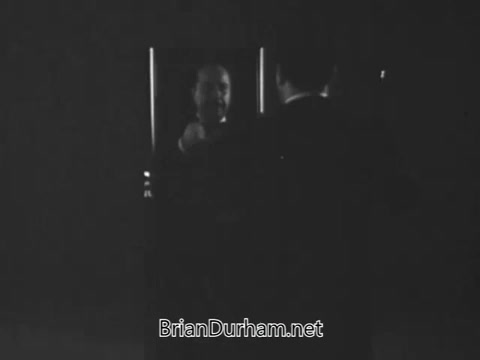 The still from the 1968 PSA 'Get Yourself Tested for Diabetes' features a dialogue where an older man, possibly overweight and fatigued, is advised by a doctor or figure of authority about the importance of getting tested for diabetes. The scene focuses on health awareness, emphasizing familial history and the need for a blood test despite feeling fine. The visual style is typical of the era, likely in black and white, reflecting a serious tone aimed at educating the public on health monitoring. The message underscores the importance of proactive health checks as one ages.