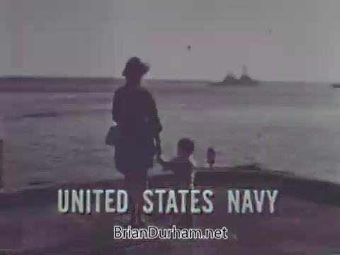 The still from the 1968 US Navy PSA features a silhouette of a woman and a child standing by the water's edge, with a view of a naval vessel in the background. The text 'UNITED STATES NAVY' is prominently displayed at the bottom. The scene conveys a sense of contemplation and connection to the Navy.