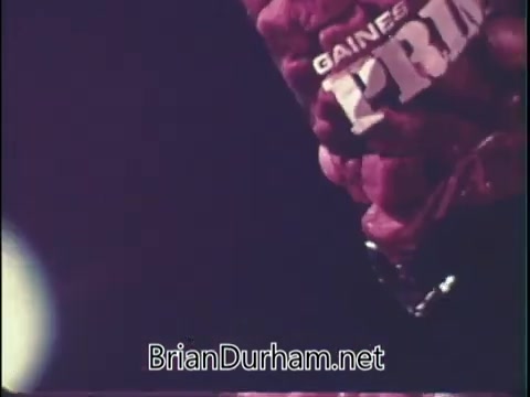 The still features a close-up of a bag of Gaines' Prime dog food, prominently displaying the brand name 'PRIME.' The background is blurred, with a soft glow, likely to draw focus to the product. The image conveys a promotional context, likely aimed at showcasing the dog food's appeal.