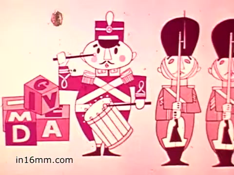 The still from the 1960s animated PSA for Muscular Dystrophy features a colorful, stylized depiction of a drummer in a military uniform, standing next to blocks that spell out 'GIVE'. Two soldiers stand by as sentinels. The overall aesthetic is playful and aimed at engaging children and families in a charitable cause. The emphasis is on giving support to the Muscular Dystrophy Association, promoted through a cheerful and lighthearted visual approach.