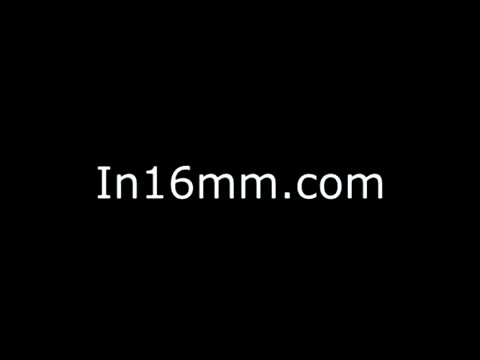 The still features text on a black background, specifically 'In16mm.com.' This indicates that it is a promotional or informational image related to the 16mm film format, possibly serving as a part of a collection or archive of films, including the Abbott Laboratories Mental Health PSA from the 1970s. The absence of any visual content focuses attention on the textual message.