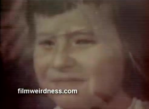 The still from the 1970 Barney's commercial features a close-up of a young girl's face, conveying a mix of emotion, likely reflecting the festive spirit of the holiday season. The color correction has been recently improved for better clarity. This commercial received a CLIO award, highlighting its impact and recognition in advertising.