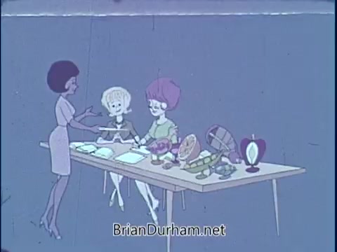 The still features a from the 1969 PSA by the American Dietetic Association. It shows a woman in a sleek outfit engaging with two other characters at a table filled with a variety of healthy foods, including fruits and dishes. The setting emphasizes nutrition and healthy eating, reflecting the era's focus on dietary education.