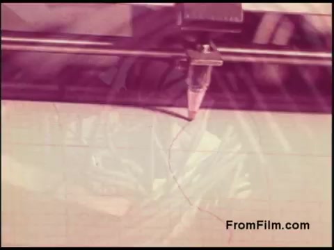 The still depicts a machinery setup likely related to film processing or telecommunications, featuring a stylus or nozzle positioned to create a curved line on a surface. The image has a soft focus and warm color tones, characteristic of 1970s film, with visible texture and grid patterns, suggesting a focus on precision and technical work in the Bell System context.