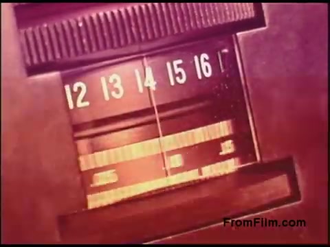 The still features a close-up view of a vintage dial, likely from a 1970s communication device, showcasing numerical indicators from 12 to 16. The dial is set against a warm color palette, suggesting an analog interface. This imagery reflects the era's technology and design aesthetics, typical of instructional films from the Bell System.