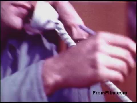 The still features a close-up of a person's hands holding a traditional telephone receiver, with the individual appearing to be engaged in conversation. The image has a warm, nostalgic color palette typical of 1970s film. The focus on the telephone suggests themes of communication from that era.