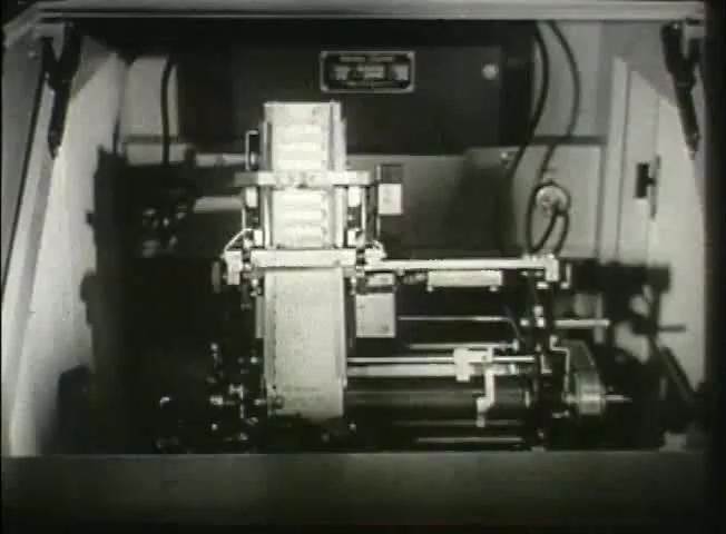 The still from 'Story Without End' features a close-up of a mechanical device likely related to telecommunications. The image showcases intricate machinery, including metal components and wiring, indicative of technology used in central offices of the Bell System during the late 1940s. This reflects the era's advancements in network infrastructure, emphasizing the complexity and functionality of telecommunication equipment at the time.
