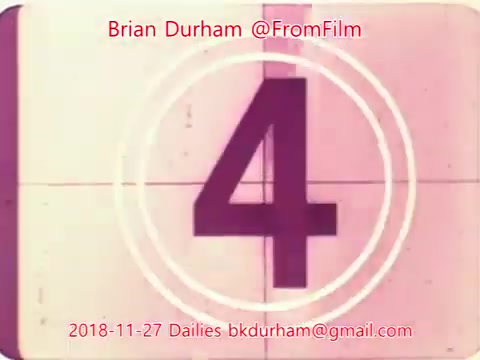 The still features a vintage-style countdown number '4' set against a faded background reminiscent of old 16mm film. The design includes concentric circles typical of a film countdown, with credits attributing the work to Brian Durham and the date, November 27, 2018, along with a contact email. The overall aesthetic conveys a nostalgic filmic quality.