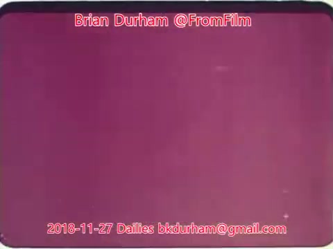 The still from the film dailies dated November 27, 2018, features a solid purple background. It includes text indicating the creator's name, Brian Durham, along with the source (@FromFilm) and an email address for further contact. The image lacks additional visual elements or context beyond the text and color.