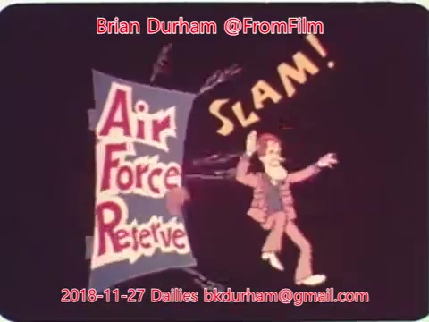 The still features a vibrant animation with the text 'Air Force Reserve' prominently displayed. A character, depicted in a cartoon style, is shown dynamically interacting with the title, as indicated by the word 'SLAM!' suggesting a sense of energy or action. The overall aesthetic is colorful and playful, typical of mid-20th-century animated shorts. The date and creator's information are also included in the image.