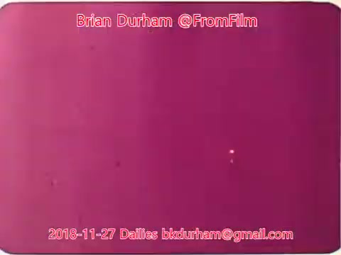 The image is a still from a 16mm film dated November 27, 2018, associated with Brian Durham's '@FromFilm' project. It features a predominantly purple background, with some visible artifacts or small points of light. The text overlay includes the date and contact email, suggesting this is part of a collection of film dailies related to a project titled 'dristan.' The overall look gives a vintage aesthetic typical of film footage.