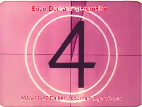 The still features a vintage film countdown frame displaying the number '4' against a pink background. Circles surround the number, indicating a classic film reel countdown. The image includes text credits identifying Brian Durham and the date of November 27, 2018, along with an email address.
