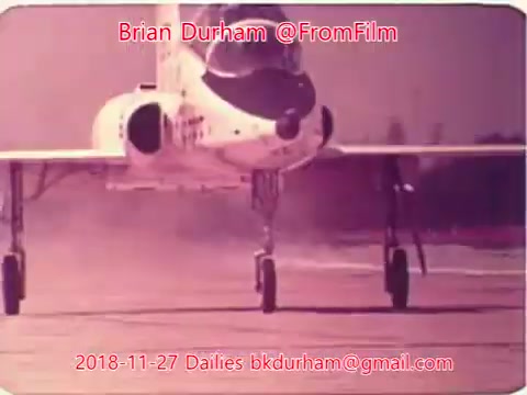 The still features a jet aircraft on a runway, showing the nose and front landing gear. The image has a vintage aesthetic, likely from a film shot. It's tagged with the date November 27, 2018, and attributed to Brian Durham, along with an email address and the title 'Dristan Dailies.' The background appears foggy, enhancing the retro vibe.