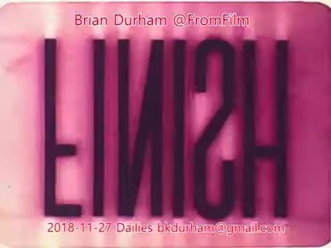 The still features the word 'FINISH' prominently displayed in a stylized font, with a pink hue dominating the background. The date '2018-11-27' and the name 'Brian Durham' are included, indicating it is part of film dailies from '@FromFilm'. The overall aesthetic suggests a vintage or experimental film influence.