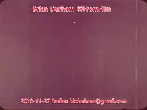 The 16mm still features a primarily purple-toned background with a small white dot in the center. The image is framed and includes text at the bottom identifying Brian Durham, the date (November 27, 2018), and the email contact, formatted in a visually engaging manner.