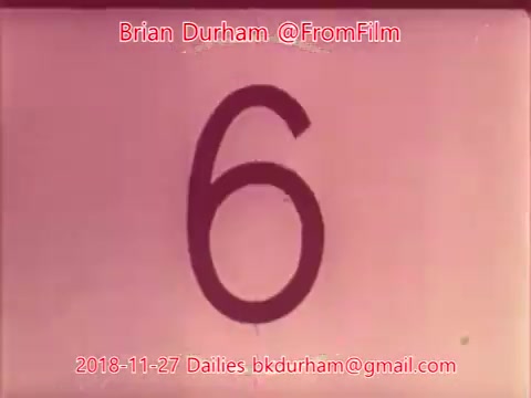 The still features a large, black number '6' on a pink background. The image has a vintage aesthetic, typical of 16mm film, and includes credits and contact information for Brian Durham, dated November 27, 2018.