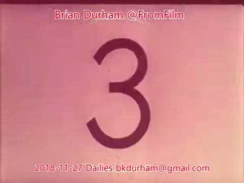 The still features a large, stylized number '3' displayed prominently against a pinkish background. It appears to be a film countdown frame, likely indicating the third take or scene in the dailies footage from November 27, 2018. The text overlay includes attribution to Brian Durham and contact information.
