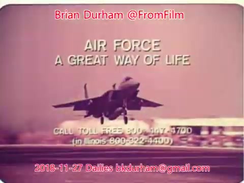 The still features a military aircraft taking off or landing, with 'AIR FORCE A GREAT WAY OF LIFE' prominently displayed as part of a recruitment advertisement. Contact information for inquiries is provided, including a toll-free number. The date and source details, '@FromFilm Dailies November 27, 2018,' are also included. The overall tone suggests a promotional emphasis on the benefits of joining the Air Force.
