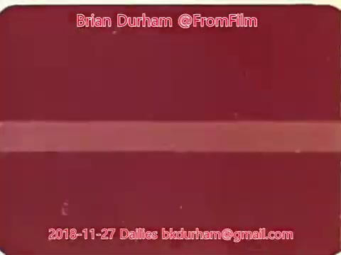 The still is a 16mm film frame featuring a solid red background with a faint horizontal stripe. It includes text identifying the creator as Brian Durham, along with a date of November 27, 2018, and an email address. The overall appearance suggests a film frame or a title card.