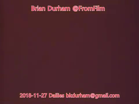 The still appears to be a simple, gradient background likely from a film capture, with text overlay that includes the name 'Brian Durham,' the handle '@FromFilm,' and a date referencing the dailies from November 27, 2018. The overall effect is minimalistic, focusing on the text rather than an image or scene.