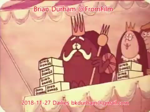 The still features an animated scene with a walrus-like king character wearing a crown and holding a scepter, surrounded by whimsical characters. The king is seated at a table stacked with boxes labeled 'Ding Dongs.' The overall aesthetic is colorful and cartoonish, suggesting a lighthearted theme. The image includes text with credits for Brian Durham and a date of November 27, 2018.