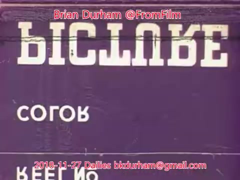 The still features a vintage 16mm film frame with text in a stylized font, possibly indicating the title or theme of a film segment. The background is a solid color, emphasizing the text and creating a nostalgic feel typical of old film stock. The date and email information suggest it's part of a collection or project, likely related to the screening or archiving of cinematic material.