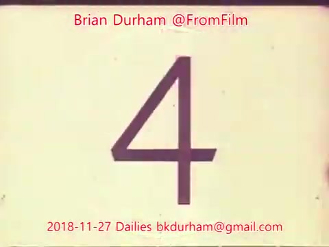 The still features a large, prominent number '4' on a light background. It includes text attributing it to Brian Durham and '@FromFilm', along with a date (November 27, 2018) and an email address. The aesthetic suggests a classic film or vintage style typical of 16mm dailies, emphasizing simplicity and a nostalgic look.