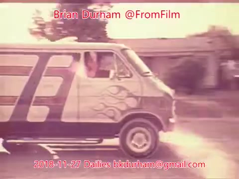 The still depicts a vintage van with a stylized flame design, captured in a warm, soft-focused 16mm film style. The van is in motion, suggesting a dynamic scene. The background features residential elements, enhancing the nostalgic feel of the image. Text overlays provide contextual details about the film dailies associated with Brian Durham from November 27, 2018.