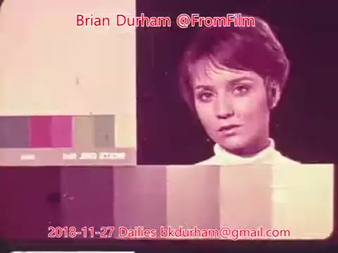 The still features a woman with short hair, looking directly at the camera. She appears to be part of an old color test or calibration scene, as indicated by the color swatches displayed beside her. The scene has a vintage aesthetic typical of 16mm film. The date and credits, including Brian Durham's contact information, are overlaid at the bottom.