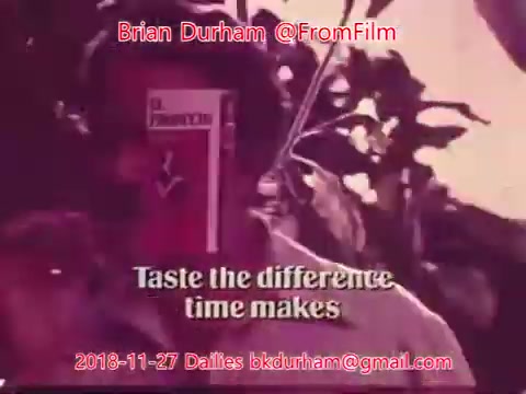 The still features a person partially obscured by a product labeled 'Dristan.' The text at the bottom reads, 'Taste the difference time makes,' suggesting a promotional or advertising context. The image has a vintage aesthetic typical of 16mm film.