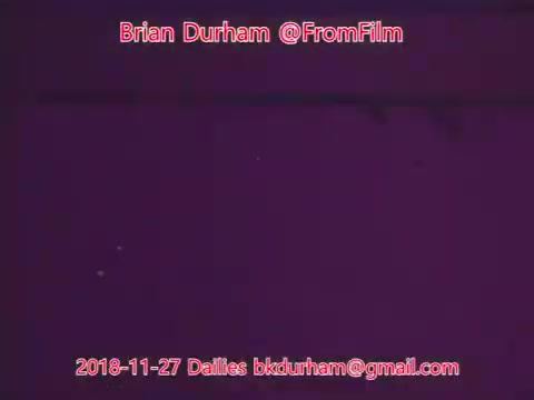 The still features a purple-toned background with minimal visible details. Text overlays include the date and contact information for Brian Durham, associated with '@FromFilm'. The overall appearance suggests it is part of a film daily, likely showcasing early footage or test shots from a project titled 'ffn035-dristan.'