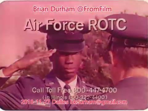 The still features a young man in an Air Force ROTC uniform saluting another individual, likely a superior, during a formal ceremony. The background appears to have a pinkish hue, giving the image a vintage feel typical of 16mm film. Overlay text includes information about the Air Force ROTC program and a contact number.