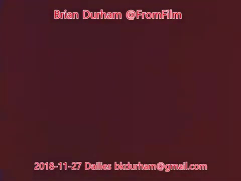 The still appears to be a digital reproduction of a 16mm film frame, featuring minimal visual elements with a solid color background. Text is overlayed, identifying 'Brian Durham' and '@FromFilm' along with a date and an email address. Overall, it serves as a cataloging or branding element rather than a scene from the film.