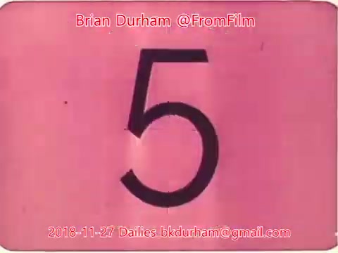 The still features a large, bold numeral '5' on a pink background. It appears to be a countdown or marker from a film roll, likely part of the dailies for a project dated November 27, 2018, associated with Brian Durham. The overall aesthetic suggests an old film presentation style.