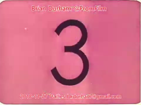 The still features a pink background with the large numeral '3' prominently displayed. It is part of a film dailies sequence, possibly indicating a countdown or marker in the film editing process. The credit at the top identifies the source as Brian Durham from @FromFilm, dated November 27, 2018, along with an email address for further contact.