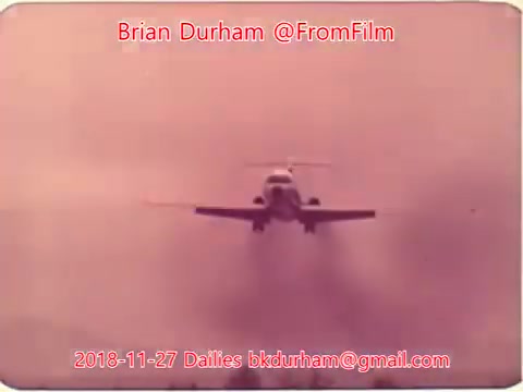 The still shows a plane approaching in a misty, pinkish atmosphere, capturing a dramatic takeoff or landing moment. The image is attributed to Brian Durham, dated November 27, 2018, as part of the '@FromFilm Dailies' series.