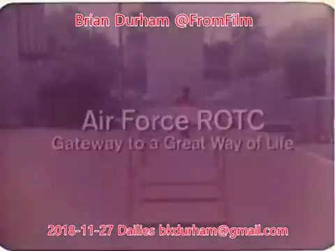 The still features a promotional screen for 'Air Force ROTC' with the tagline 'Gateway to a Great Way of Life.' The image has a vintage aesthetic, likely due to its 16mm film origin, and includes text details indicating the source and contact information. The background appears blurred, further emphasizing the title and tagline.