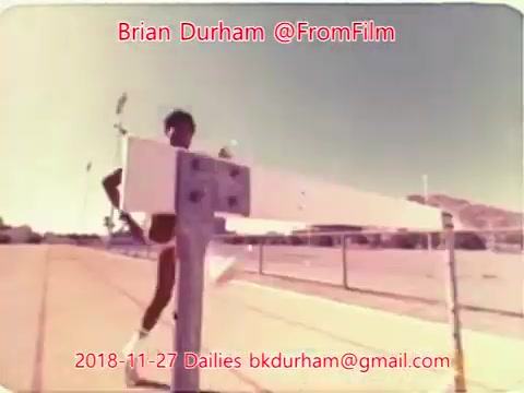 The still features a male athlete running on a track, captured in a vibrant, vintage 16mm film style. The image conveys a sense of motion and energy, with the background suggesting an outdoor sports environment. Text overlays provide context, indicating it is part of the '@FromFilm Dailies' collection dated November 27, 2018.