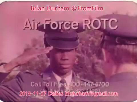 The still features a young man in military attire saluting, indicating a formal or ceremonial context, possibly related to the Air Force ROTC. The image includes text with contact information for inquiries about the program. The setting appears outdoors, with focus on the interaction between two individuals in uniform.