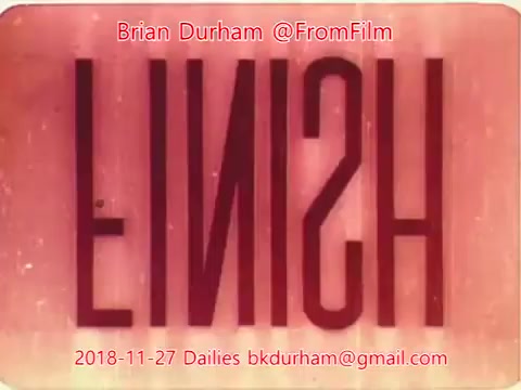 The still features the word 'FINISH' presented in a stylized, reversed format, likely used as a title card or ending marker in a film. The background has a faded, pinkish hue, giving it a vintage appearance typical of older 16mm films. The text is prominent and centered, adding to the emphasis on closure or completion. Additional details include the name 'Brian Durham' and the date '2018-11-27,' indicating it is part of a series of dailies from that date.