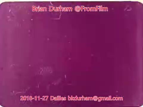 The 16mm still features a purple-toned frame with a textured surface, hinting at age and film grain. Overlay text includes the username 'Brian Durham,' the date '2018-11-27,' and a contact email, indicating it is part of a daily film review or collection titled 'ffn035-dristan-dailies.' The overall presentation suggests a focus on film preservation or analysis.