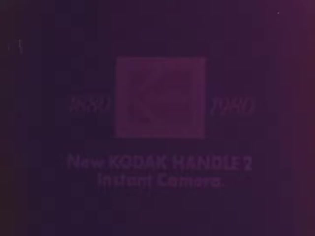 The still features the logo and text for the 'New KODAK HANDLE 2 Instant Camera,' highlighting its launch period, 1980-1981. The design appears dated, typical of 1970s advertising, reflecting Kodak's attempt to market a more affordable instant camera alternative to Polaroid. The emphasis on the product name suggests a focus on innovation and accessibility in photography during that era.