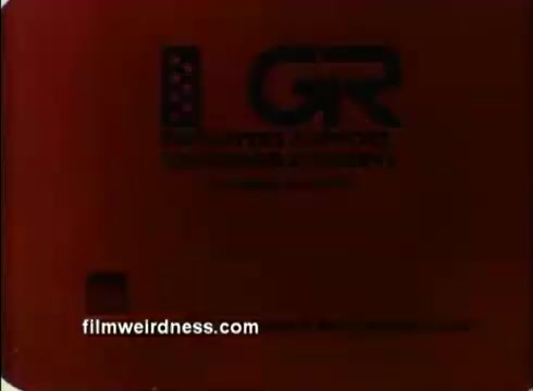 The still appears to be a screen capture from a 16mm film, likely showcasing a title card or opening segment from a 1970s Air Force Public Service Announcement (PSA). The image features a logo with stylized letters 'GR' alongside an American flag, suggesting it's an official production. The dominant red background could indicate a dramatic or attention-grabbing theme typical of PSAs from that era. The text visible indicates it may pertain to the United States Air Force.