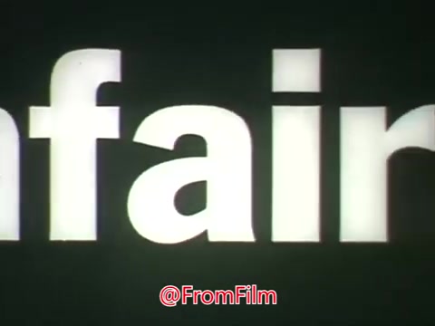The still from the 16mm print of the 'Fair Housing PSA - 1968?' prominently features the word 'Unfair,' likely emphasizing the theme of housing discrimination. The context provided includes voice-over snippets from both a male and female, highlighting the challenges faced by Black individuals in securing housing. The message communicates the frustrations and inequities in the housing market, underscoring the issue of racial discrimination during that era. The stark visual of the word paired with the voices conveys a strong social justice message.