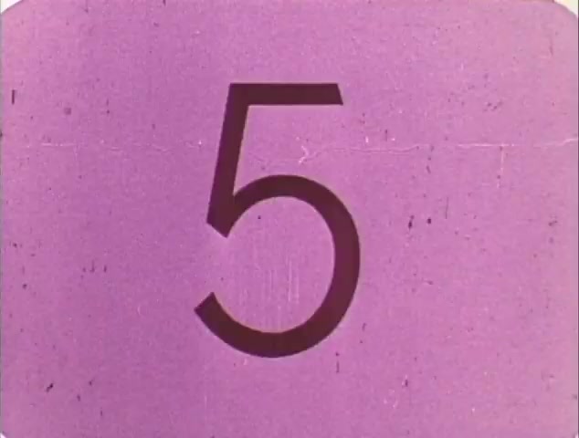 The still from the trailer features a bold, large number '5' against a textured purple background. This design likely serves as a transitional element, possibly indicating a countdown or segment marker within the TV spot trailer for 'Dirty Mary, Crazy Larry' and 'Vanishing Point.' The retro aesthetic aligns with the era of the films, enhancing the nostalgic feel of the reissue trailer. The simplicity of the visuals emphasizes the importance of the films being showcased.