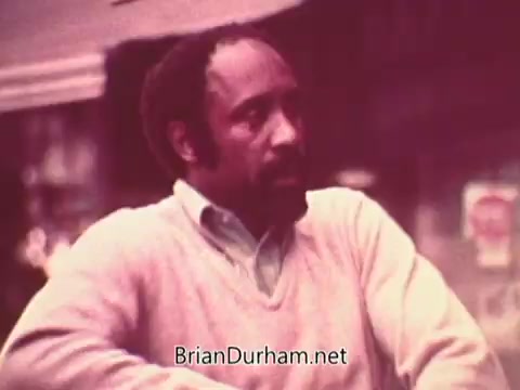 The still from 'Ohio Job Service PSA 3 - 1970s' features a man in a light sweater, appearing thoughtful or contemplative. The background suggests an urban setting, likely part of a public service announcement aimed at job-seeking or employment resources in Ohio during the 1970s. The image has a slightly muted color palette typical of that era.